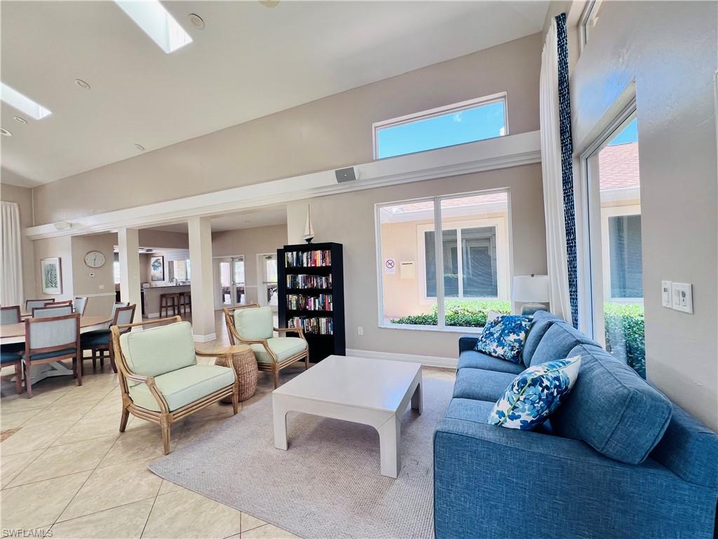 3250 West Crown Pointe Boulevard, Unit 101 Naples, FL 34112 - Photo 34 of 46 a living room with furniture and a large window