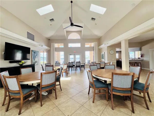 a dining room with furniture a rug and a flat screen tv