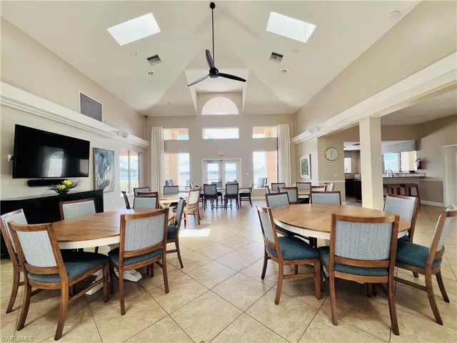 a dining room with furniture a rug and a flat screen tv