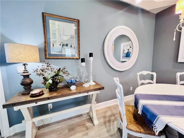 a dining room with furniture and mirror