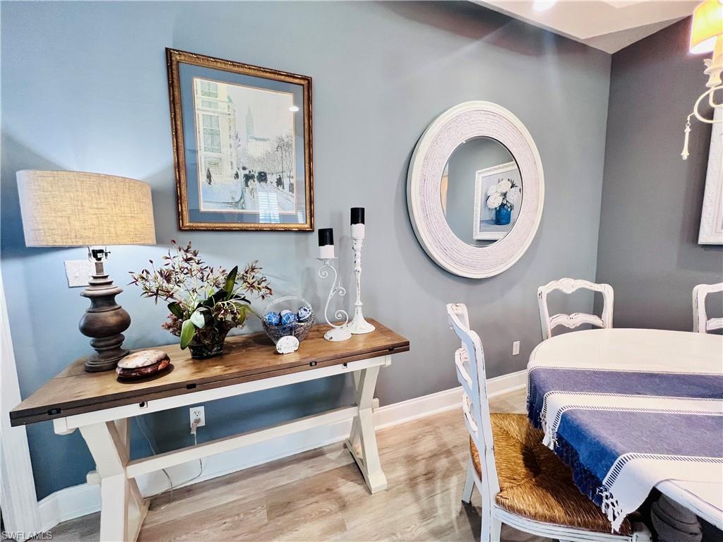 3250 West Crown Pointe Boulevard, Unit 101 Naples, FL 34112 - Photo 8 of 46 a dining room with furniture and mirror