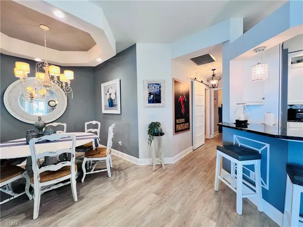 a living room with furniture a mirror and a table