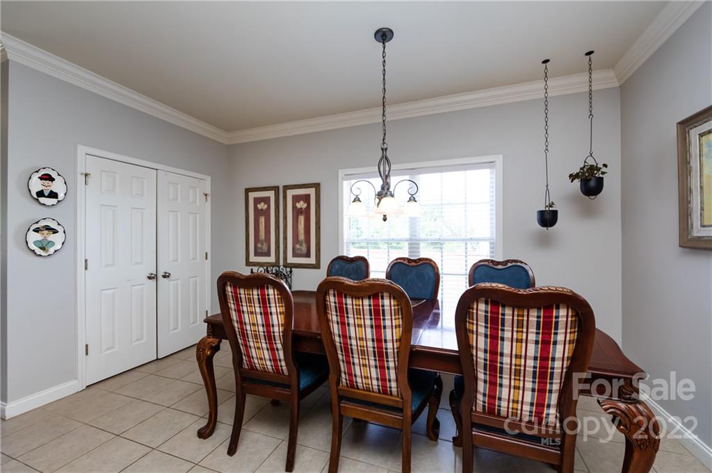 2707 Falling Leaf Court Monroe, NC 28110 - Photo 15 of 36 a view of a dining room with furniture and chandelier