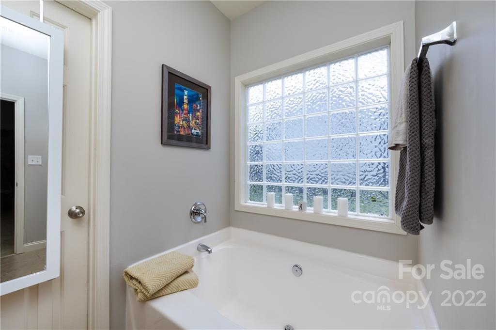 2707 Falling Leaf Court Monroe, NC 28110 - Photo 23 of 36 a bathroom with a bathtub and a window