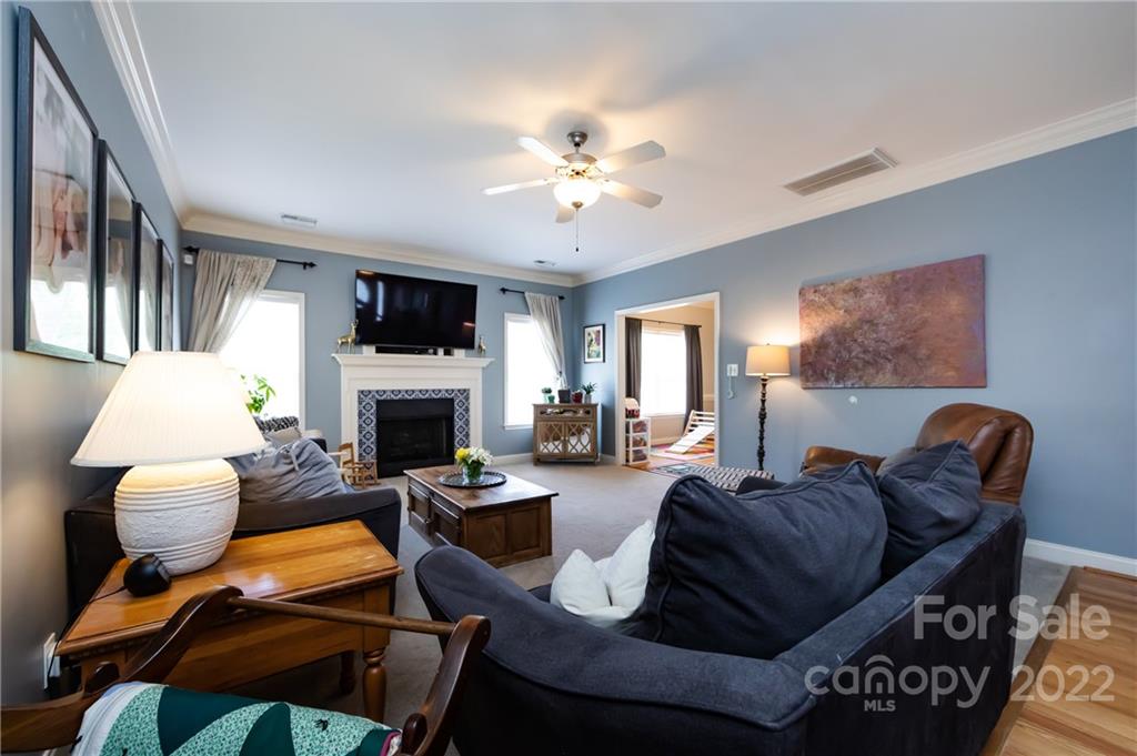 2707 Falling Leaf Court Monroe, NC 28110 - Photo 8 of 36 a living room with furniture a fireplace and a flat screen tv