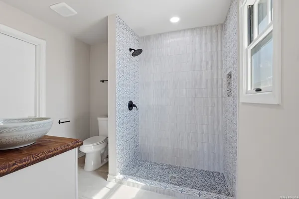 a bathroom with a sink a mirror and vanity