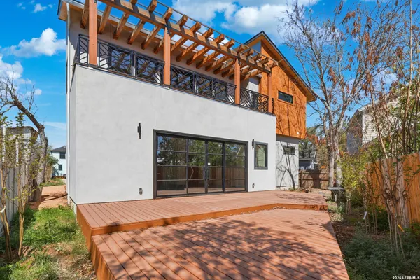 a balcony with wooden floor and furniture