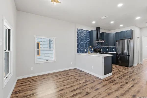 a view of a hallway with wooden floor and entryway