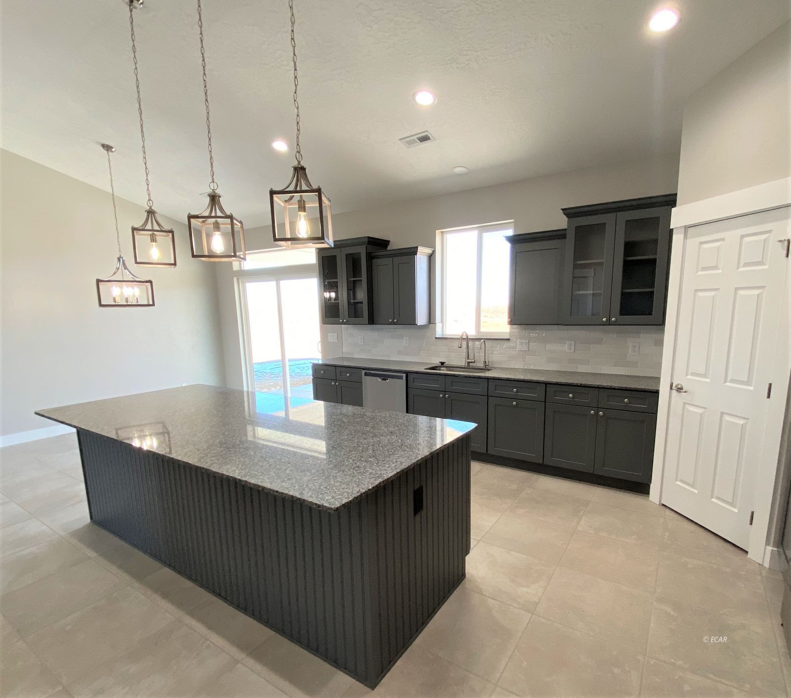 269 Sun Vly Road Spring Creek, NV 89815 - Photo 7 of 25 a kitchen with kitchen island a counter top space a sink stainless steel appliances and cabinets