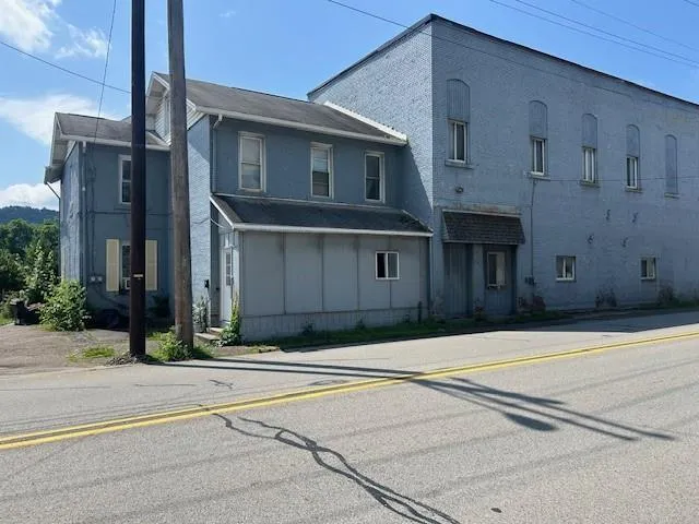 a view of a brick house with many windows