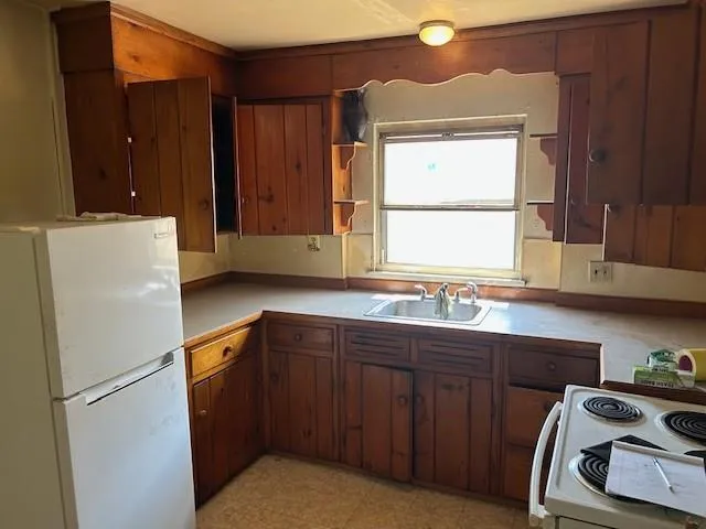 a kitchen with a refrigerator and a sink