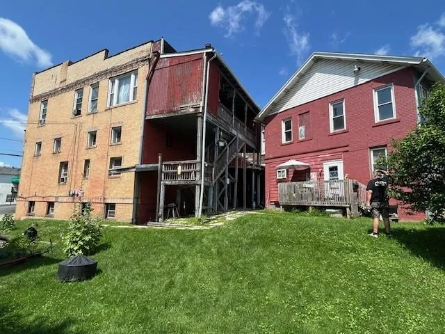 a front view of a building with a garden