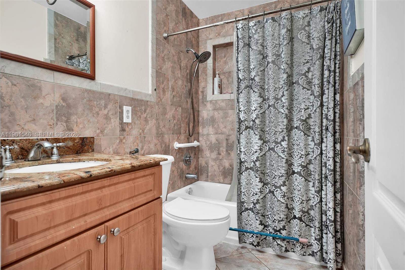 2821 Southwest 65th Avenue Miami, FL 33155 - Photo 7 of 14 a bathroom with a granite countertop sink a toilet and shower