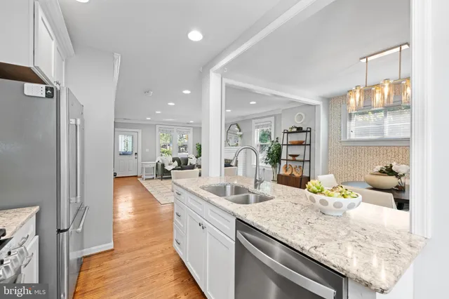 a kitchen with granite countertop a sink and cabinets