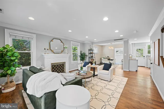 a living room with fireplace furniture and a fireplace
