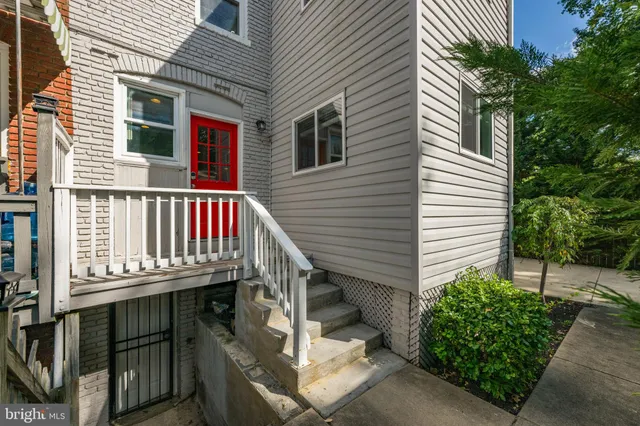 a view of a house with a deck and a yard