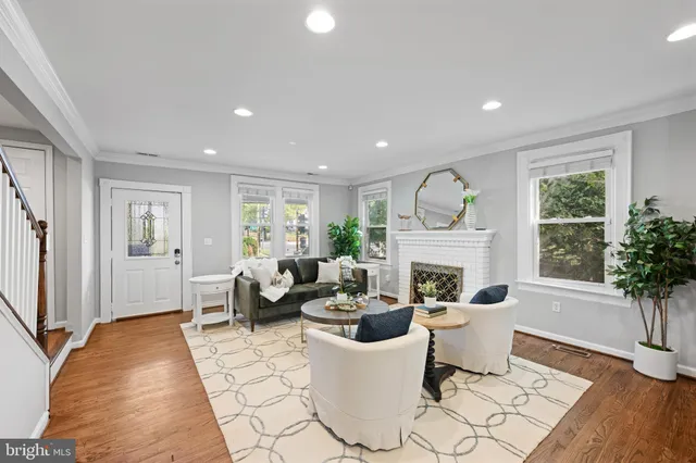 a living room with fireplace furniture and a large window