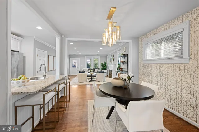 a dining hall with stainless steel appliances a table and chairs