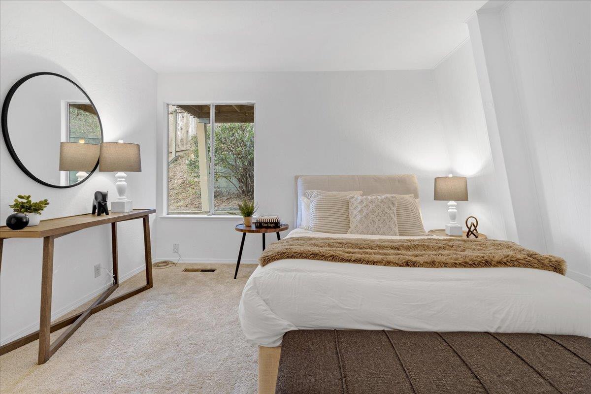 3560 Viola Drive Aromas, CA 95004 - Photo 32 of 42 a bedroom with a bed a mirror and a window