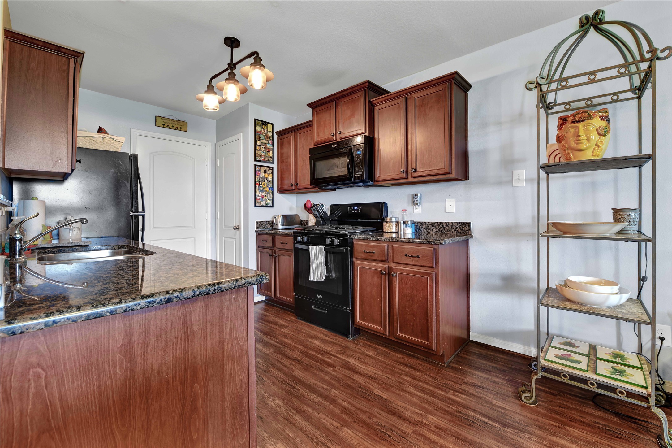 1827 Garnet Breeze Drive Rosharon, TX 77583 - Photo 8 of 23 a kitchen with stainless steel appliances granite countertop a stove a sink and a microwave