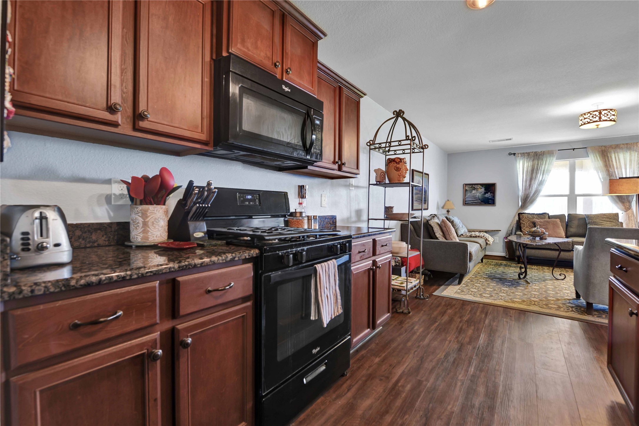 1827 Garnet Breeze Drive Rosharon, TX 77583 - Photo 9 of 23 a kitchen with stainless steel appliances granite countertop a stove and a wooden cabinets