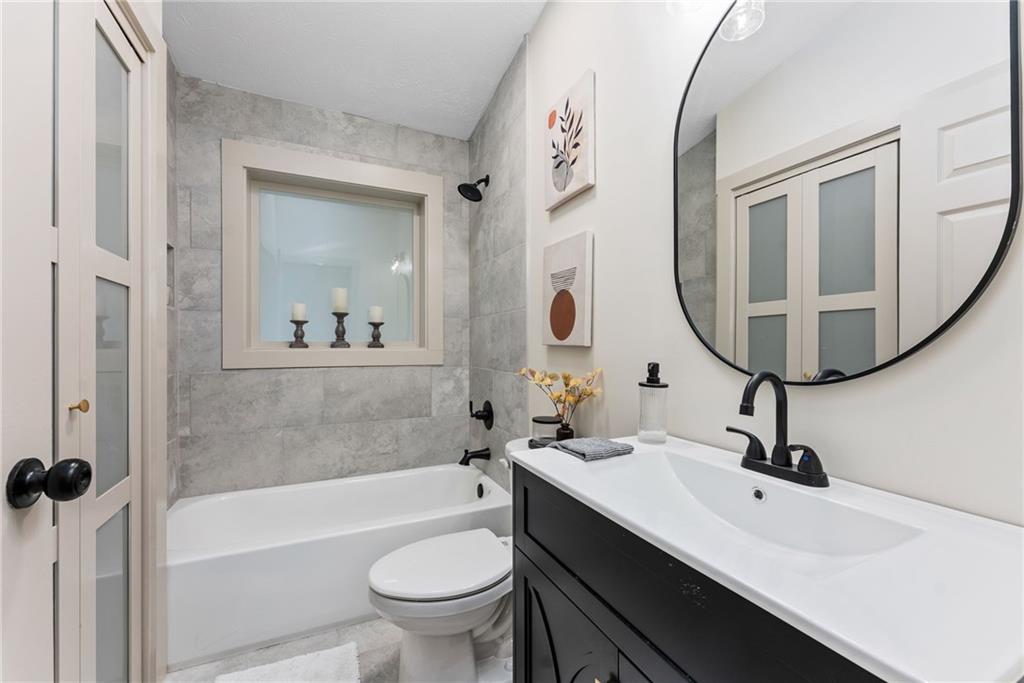 2771 Sherwood Road Southeast Smyrna, GA 30082 - Photo 14 of 40 a bathroom with a sink a toilet and a mirror