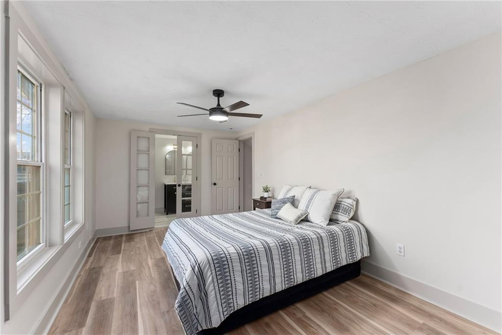 2771 Sherwood Road Southeast Smyrna, GA 30082 - Photo 21 of 40 a bedroom with a large bed and a chandelier