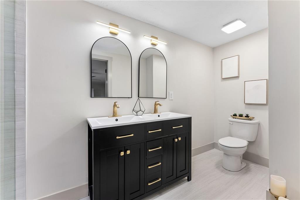 2771 Sherwood Road Southeast Smyrna, GA 30082 - Photo 22 of 40 a bathroom with a toilet sink and mirror