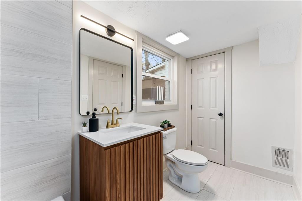 2771 Sherwood Road Southeast Smyrna, GA 30082 - Photo 27 of 40 a bathroom with a sink a toilet and shower
