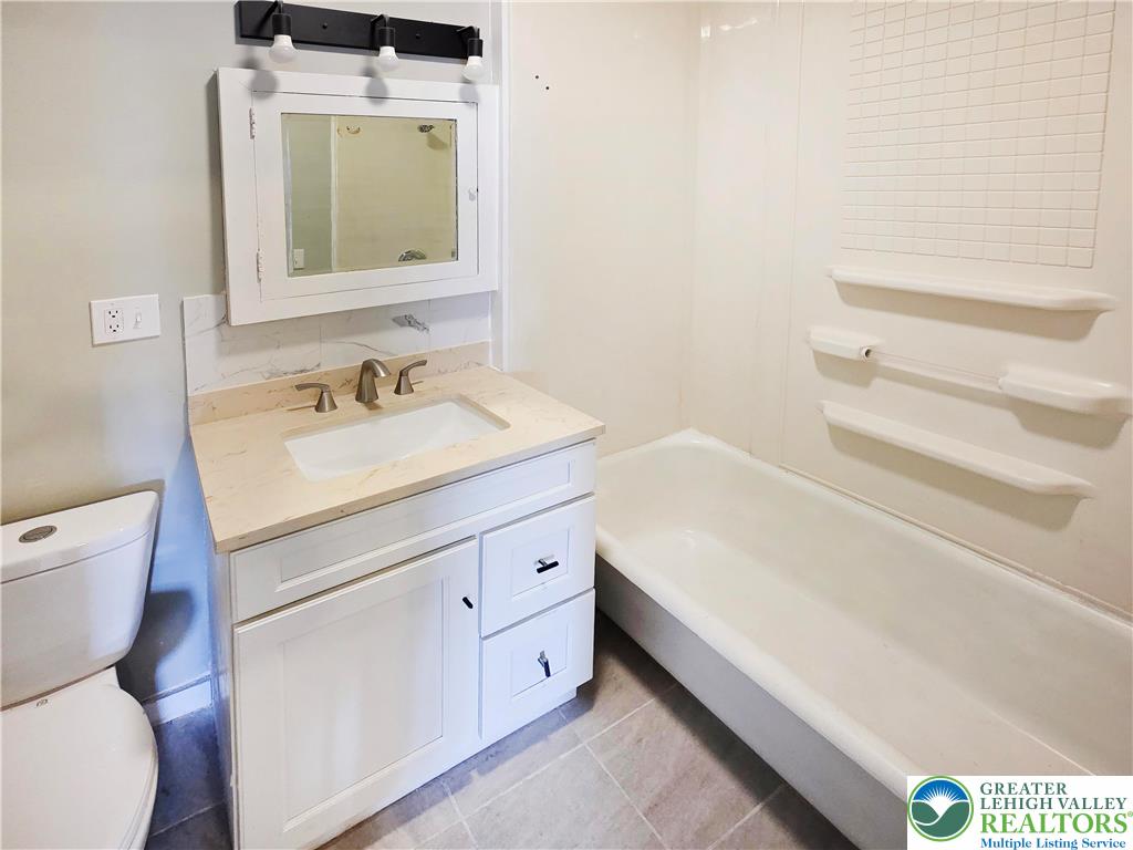 1401 Broadway, Unit 2 Bethlehem, PA 18015 - Photo 6 of 7 a bathroom with a toilet sink and mirror