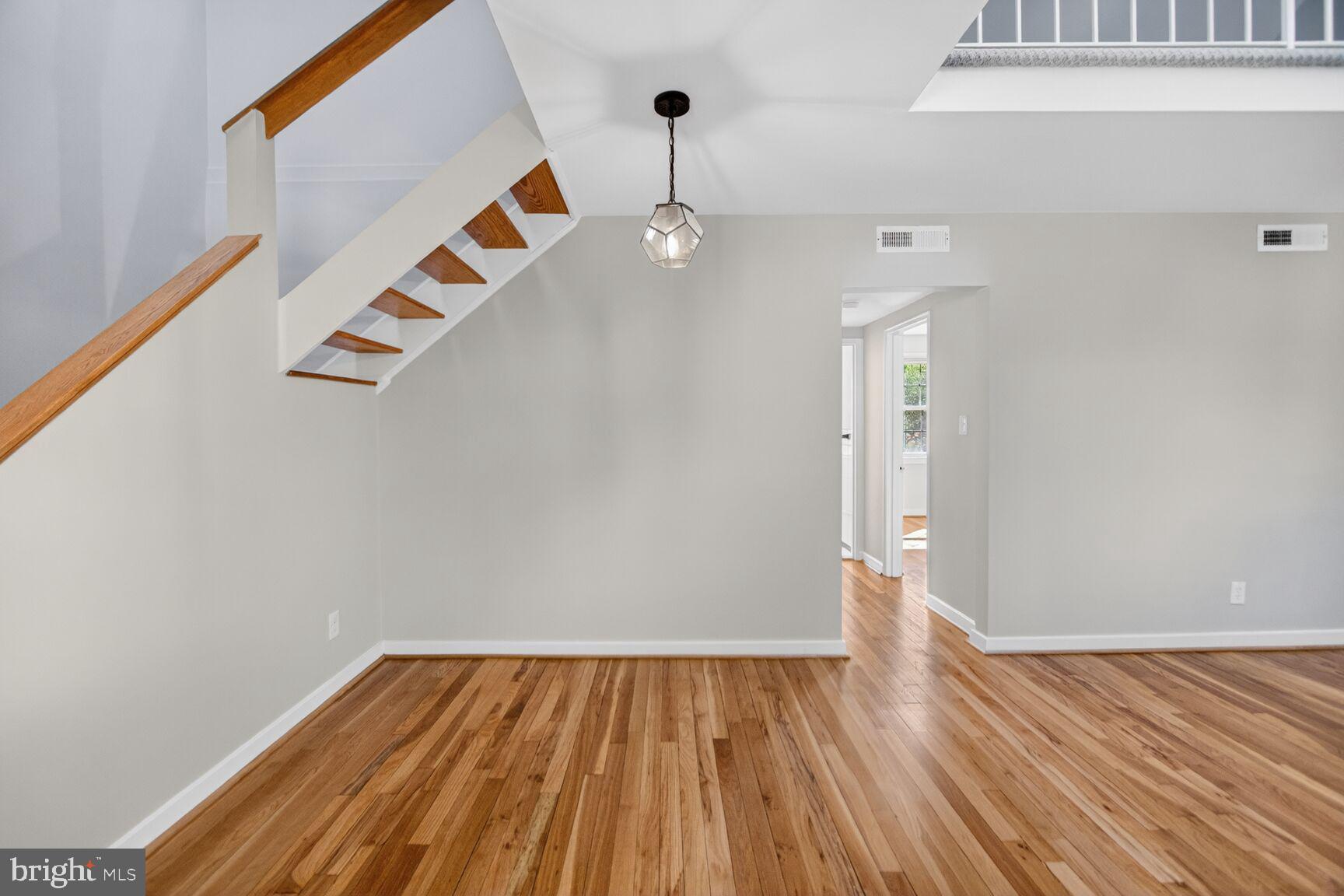 8205 Grubb Road, Unit G202 Silver Spring, MD 20910 - Photo 12 of 38 a view of an empty room with wooden floor and a window