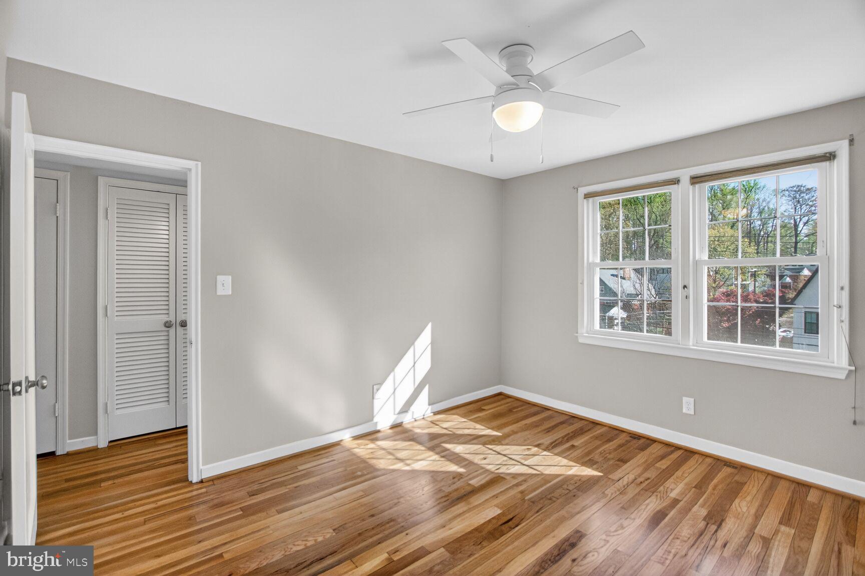 8205 Grubb Road, Unit G202 Silver Spring, MD 20910 - Photo 16 of 38 a view of a room with wooden floor and a ceiling fan