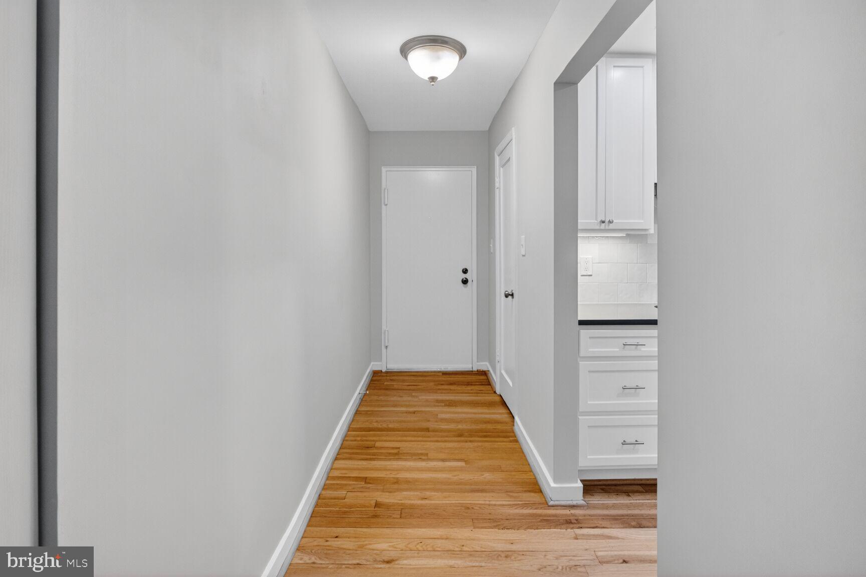 8205 Grubb Road, Unit G202 Silver Spring, MD 20910 - Photo 2 of 38 a view of a hallway with wooden floor