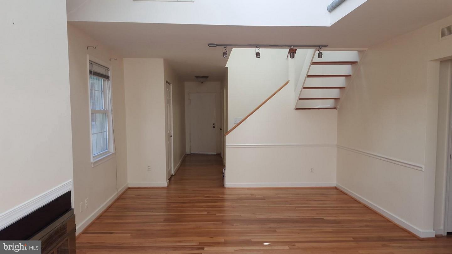 8205 Grubb Road, Unit G202 Silver Spring, MD 20910 - Photo 4 of 38 a view of a hallway with wooden floors and white walls
