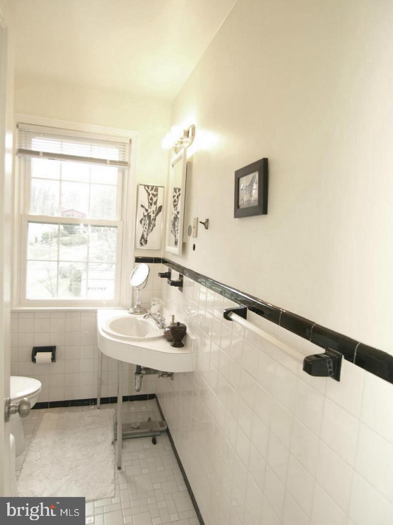 8205 Grubb Road, Unit G202 Silver Spring, MD 20910 - Photo 10 of 38 a bathroom with a sink and a mirror