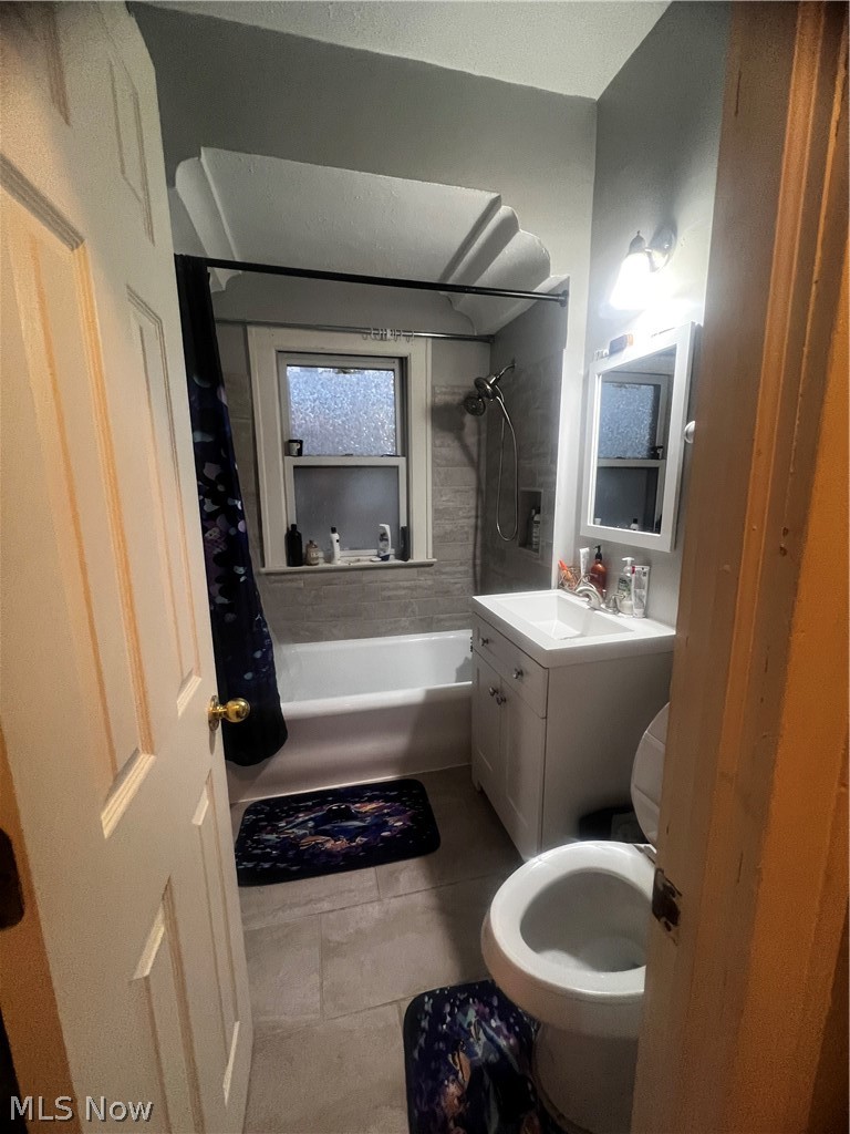 3625 Hildana Road Cleveland, OH 44120 - Photo 13 of 22 Full bathroom featuring shower / bathtub combination with curtain, tile floors, toilet, and vanity with extensive cabinet space