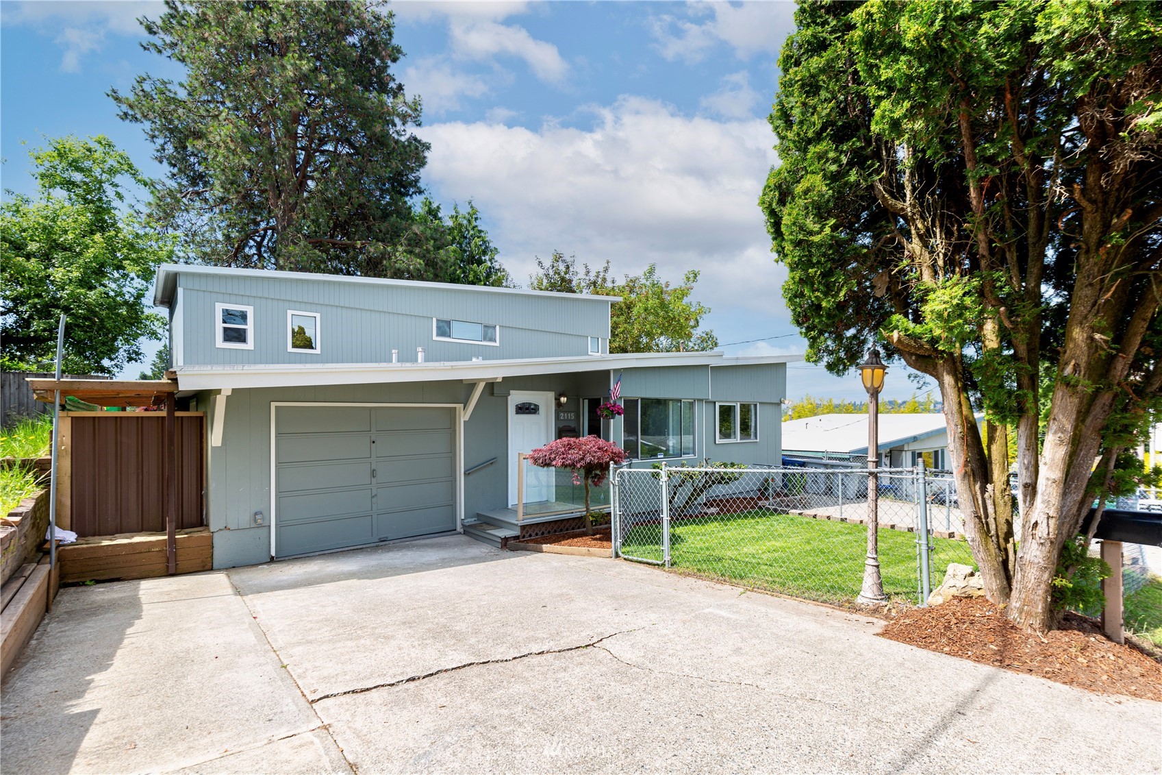 2115 Northeast 8th Street Renton, WA 98056 - Photo 1 of 19 front view of a house with a yard