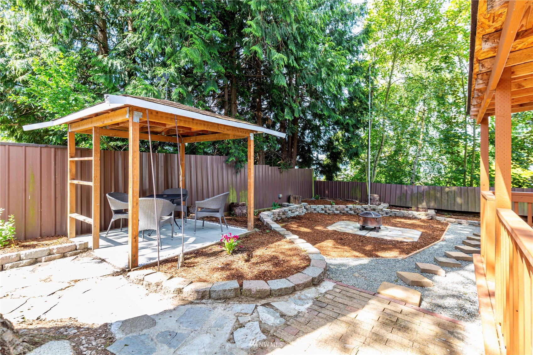 2115 Northeast 8th Street Renton, WA 98056 - Photo 15 of 19 a backyard of a house with barbeque oven table and chairs