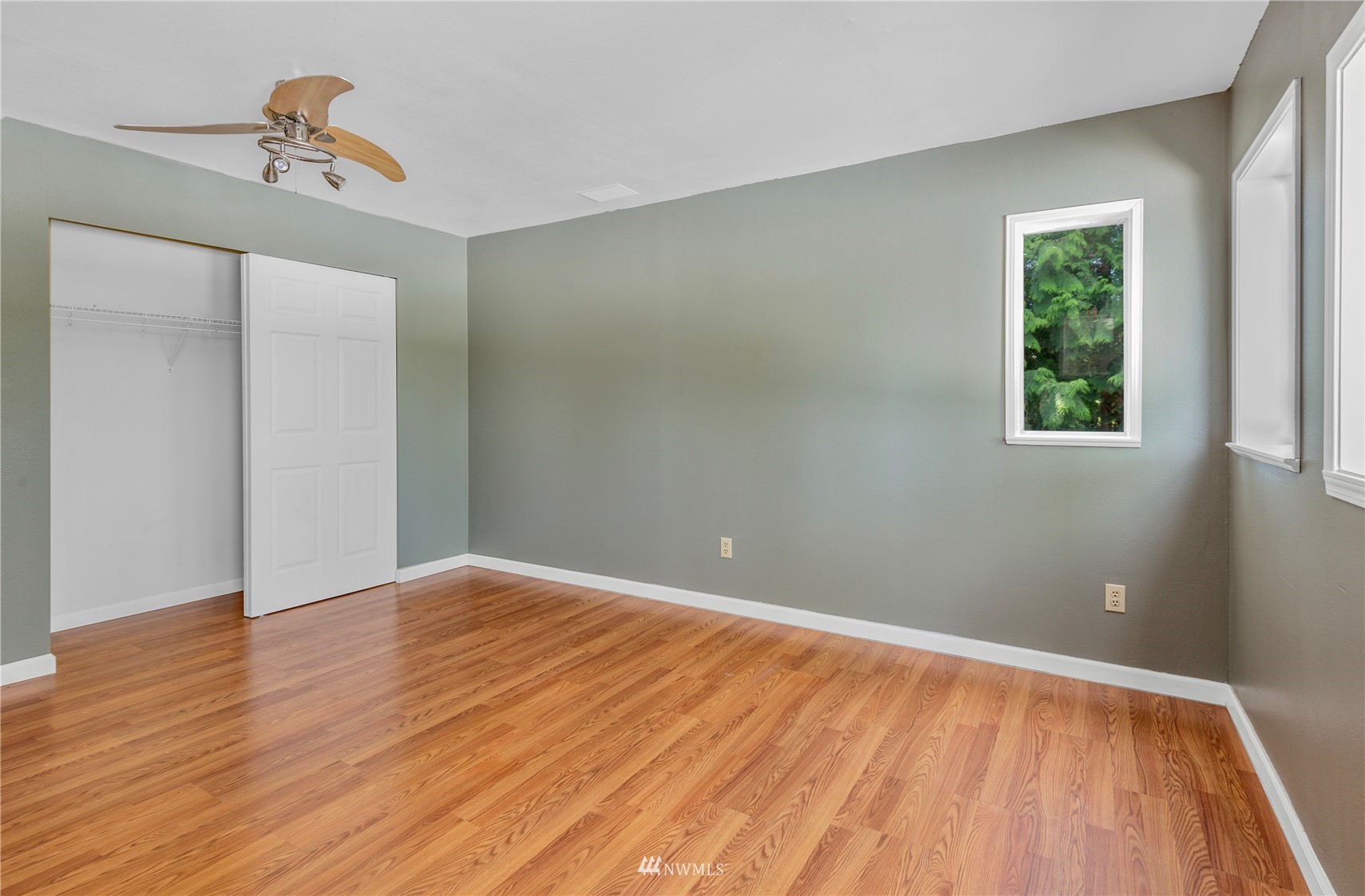 2115 Northeast 8th Street Renton, WA 98056 - Photo 19 of 19 a view of an empty room with wooden floor and a window