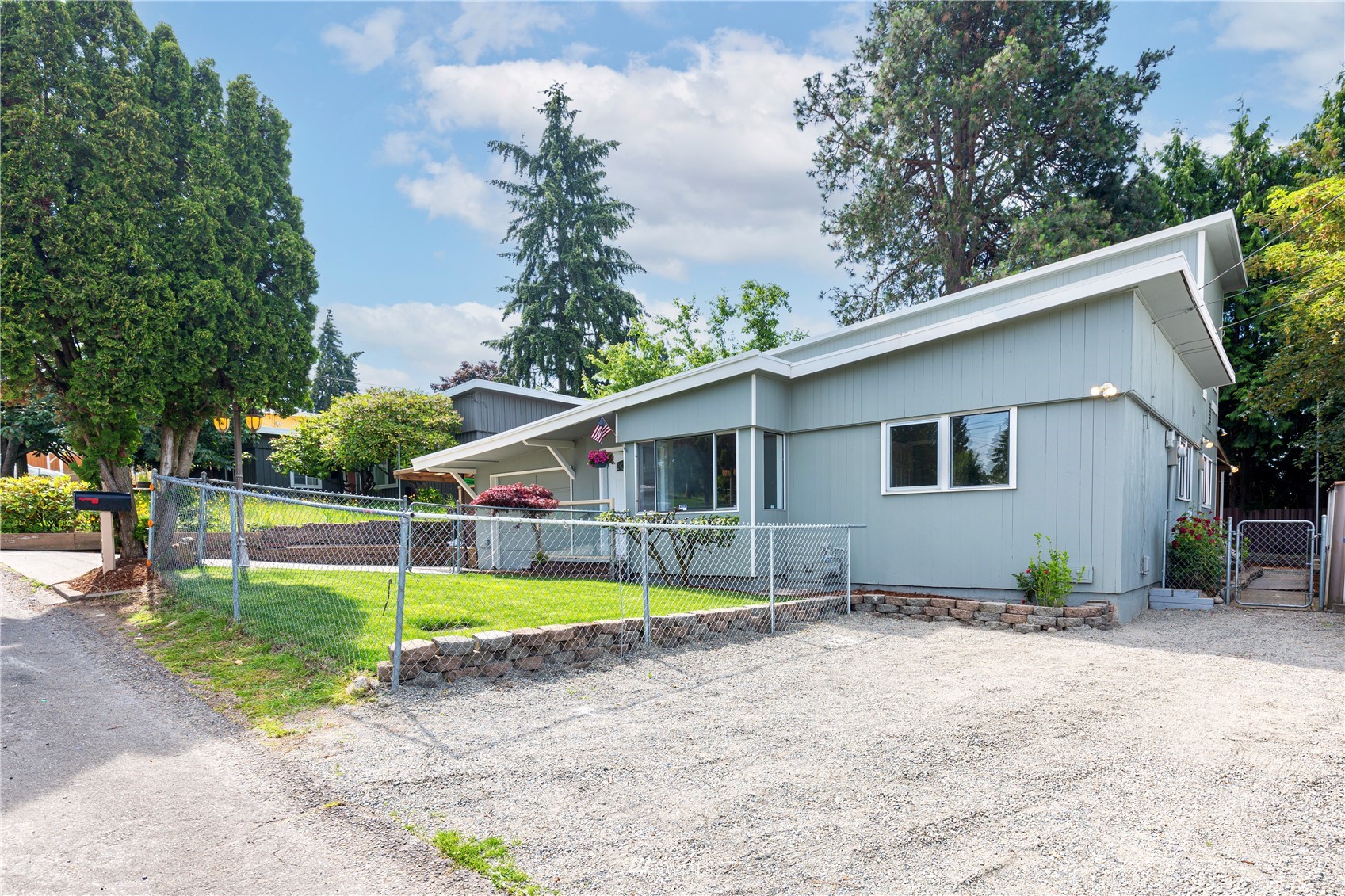 2115 Northeast 8th Street Renton, WA 98056 - Photo 2 of 19 a view of a house with swimming pool next to a yard