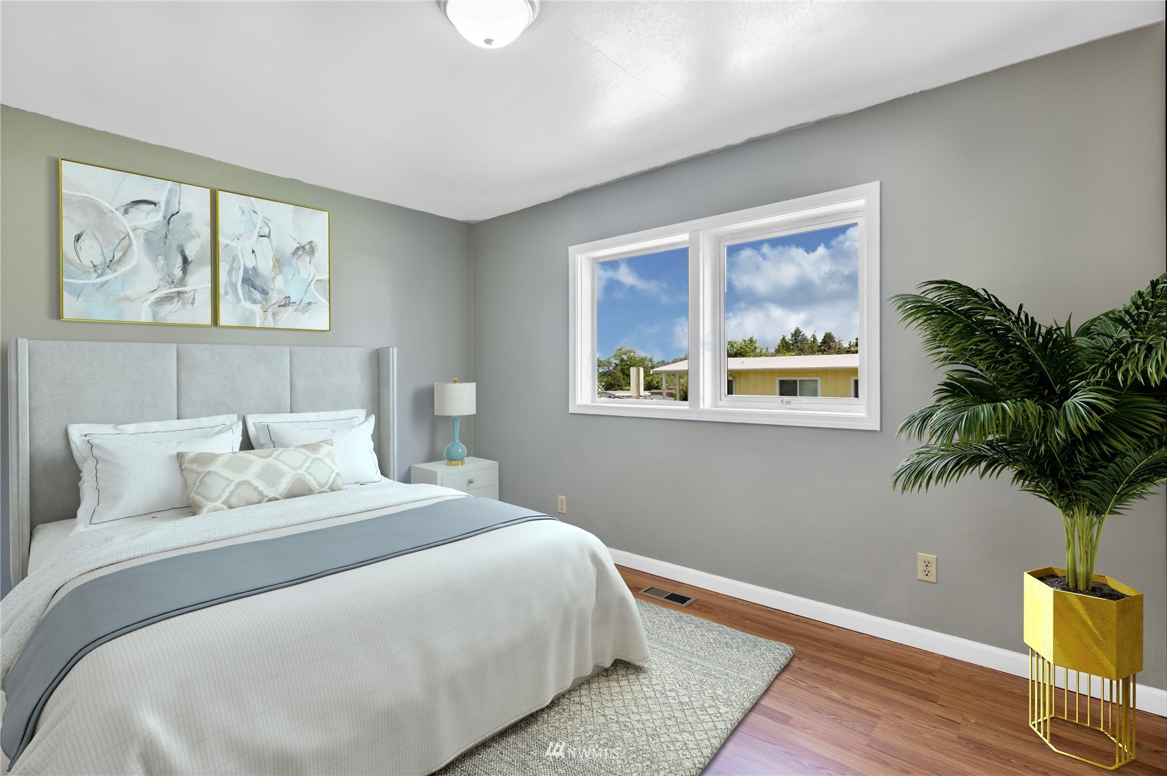 2115 Northeast 8th Street Renton, WA 98056 - Photo 4 of 19 a bedroom with a large bed and a painting on the wall