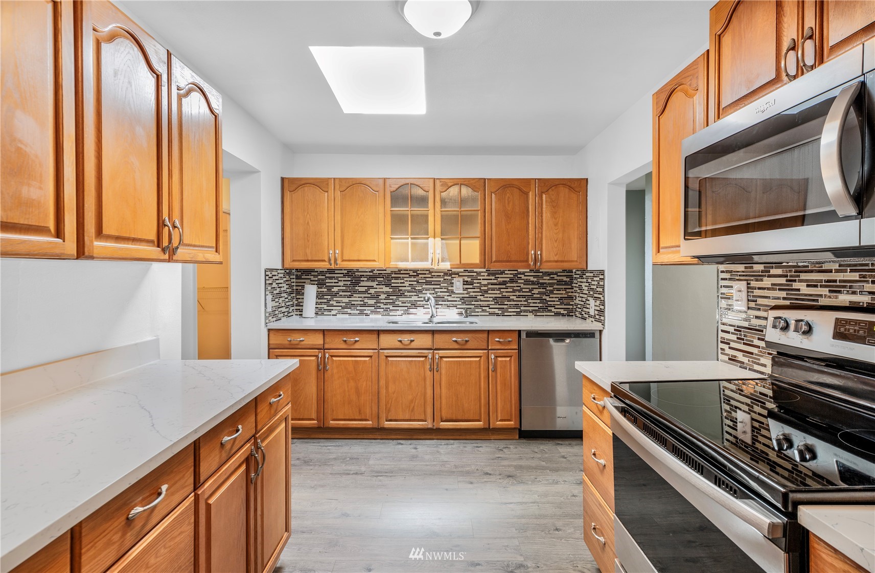 2115 Northeast 8th Street Renton, WA 98056 - Photo 5 of 19 a kitchen with stainless steel appliances kitchen island granite countertop a stove and a sink