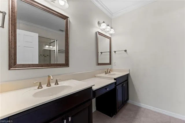 a bathroom with double sink and a mirror