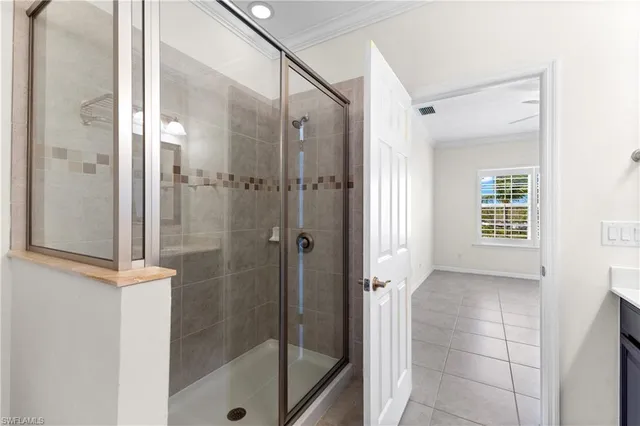 a bathroom with a shower and a glass door