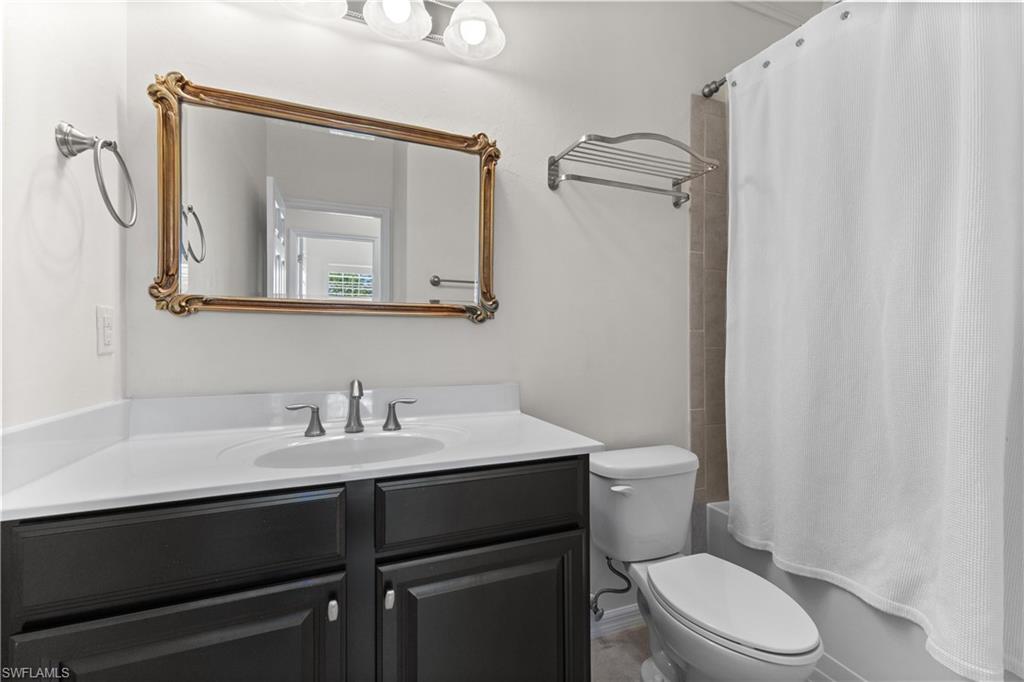 8531 Violeta Street, Unit 203 Estero, FL 34135 - Photo 21 of 35 a bathroom with a toilet sink and mirror