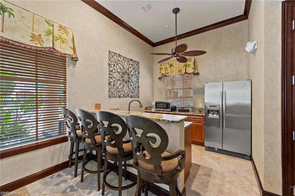 8531 Violeta Street, Unit 203 Estero, FL 34135 - Photo 30 of 35 a kitchen with a table and chairs