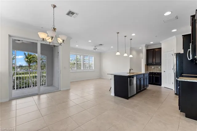 a living room with kitchen island furniture and a chandelier