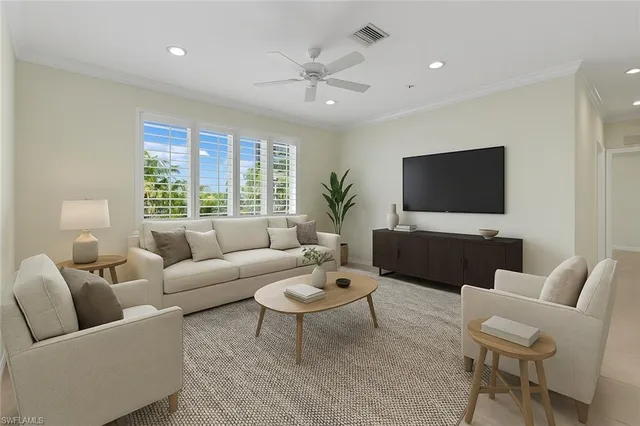a living room with furniture a flat screen tv and a large window
