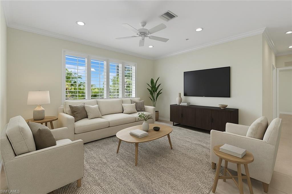 8531 Violeta Street, Unit 203 Estero, FL 34135 - Photo 4 of 35 a living room with furniture a flat screen tv and a large window