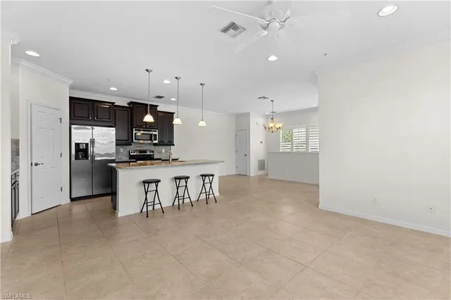 a view of kitchen with refrigerator microwave and stove